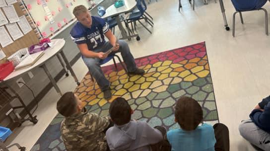 Football Players read to Igo Students